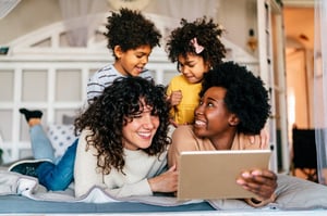 two moms playing with their young children