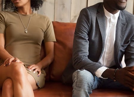 Woman and man sitting on couch