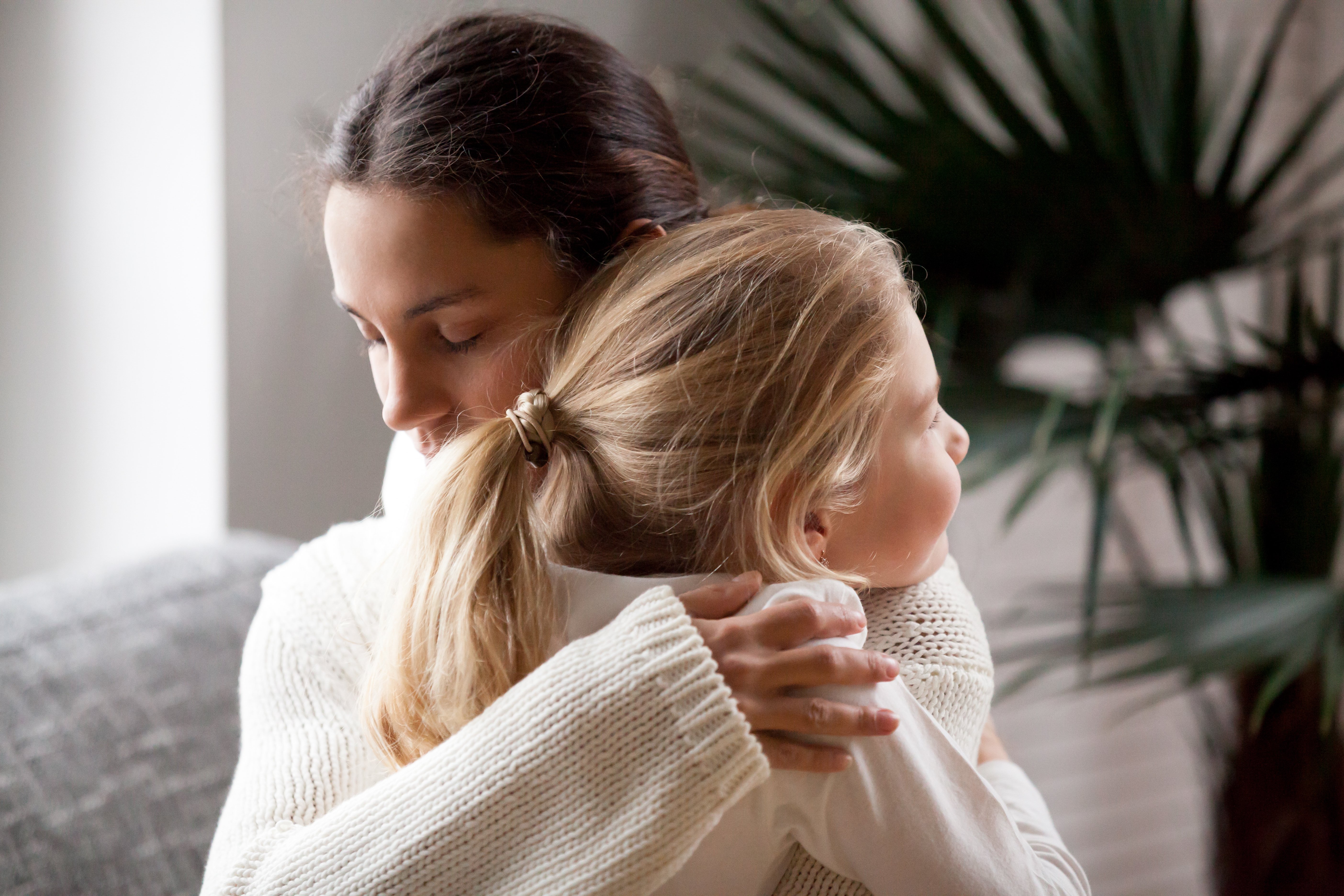 Child and mother holding hands, symbolizing family connection during the divorce process